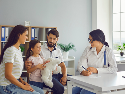 doctor with family in a primary care appointment